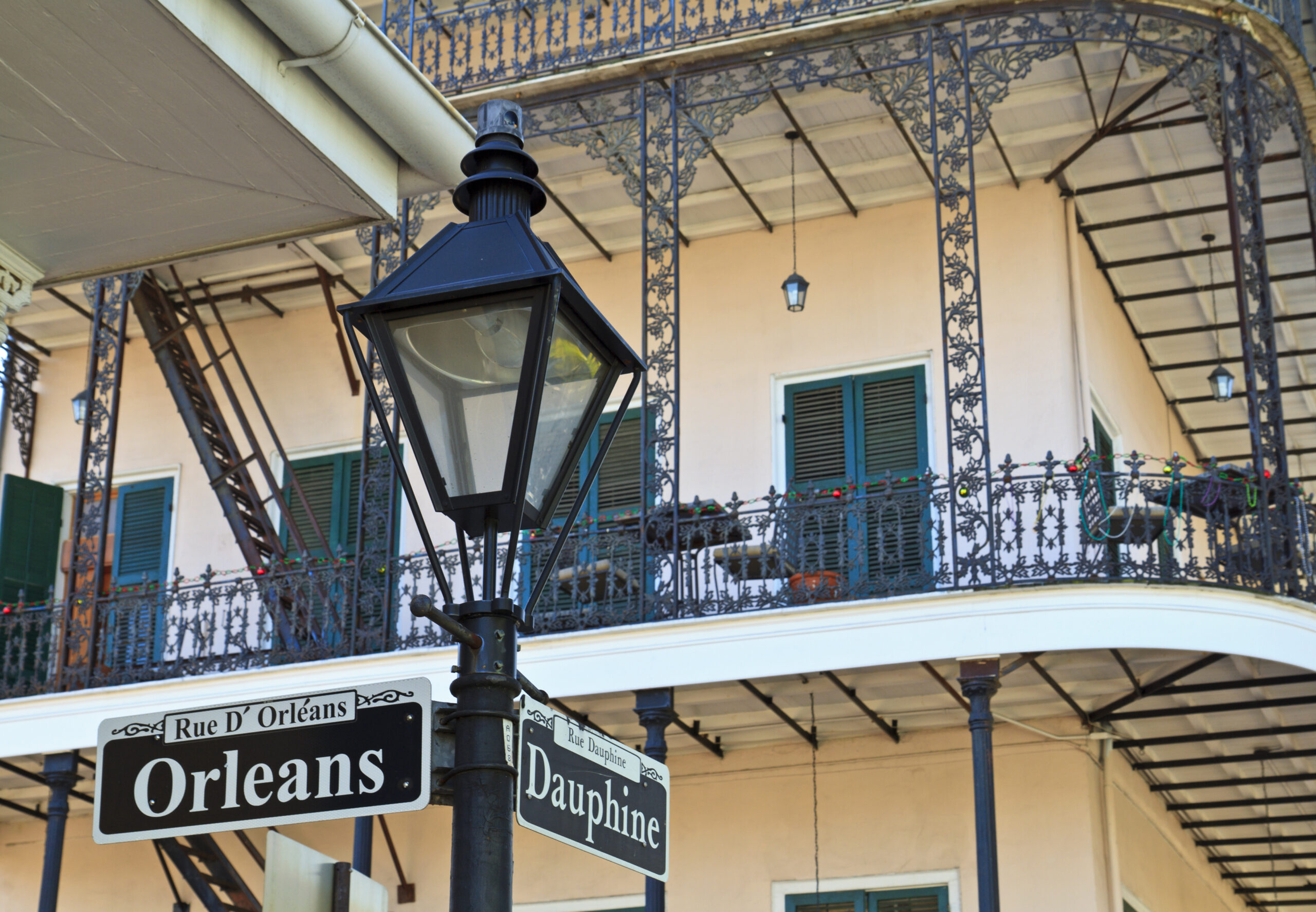 mlm incorporated orleans dauphine street building balcony wrough iron lamp post